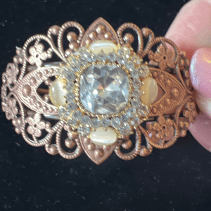 Copper filigree bracelet with cream and clear rhinestone jewel